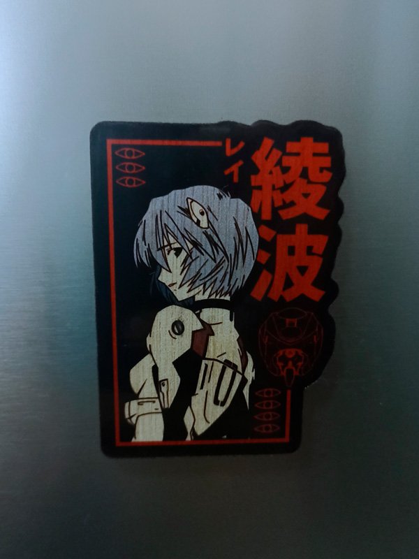 Handcrafted wooden magnet set featuring five unique designs inspired by Evangelion. Each magnet showcases detailed artwork and vibrant colors, perfect for adding a touch of anime style to any space. A must-have for fans of the iconic series.